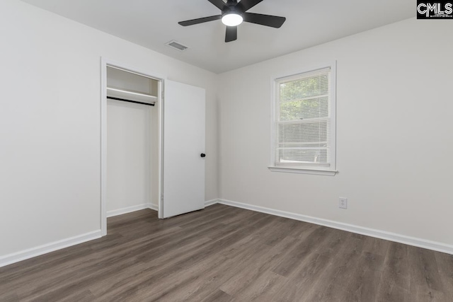 unfurnished bedroom with wood finished floors, baseboards, a closet, and a ceiling fan