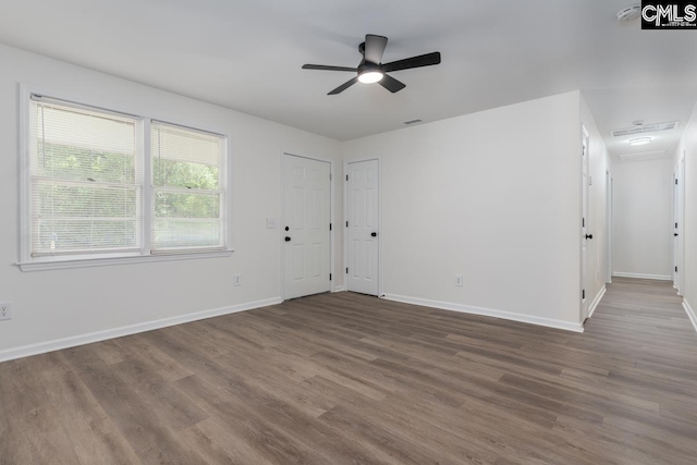 unfurnished living room featuring wood finished floors, ceiling fan, and baseboards