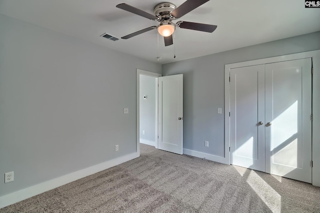 unfurnished bedroom with baseboards, carpet, a ceiling fan, and a closet