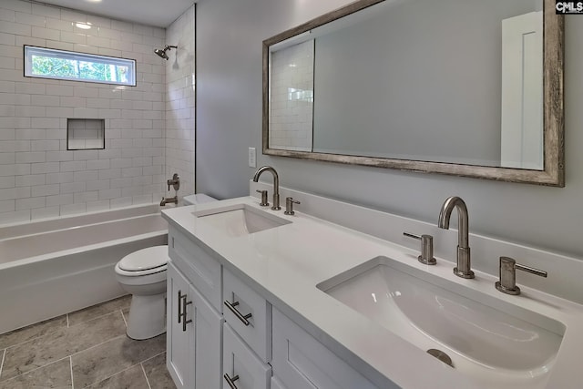 bathroom with toilet, shower / tub combination, and double vanity