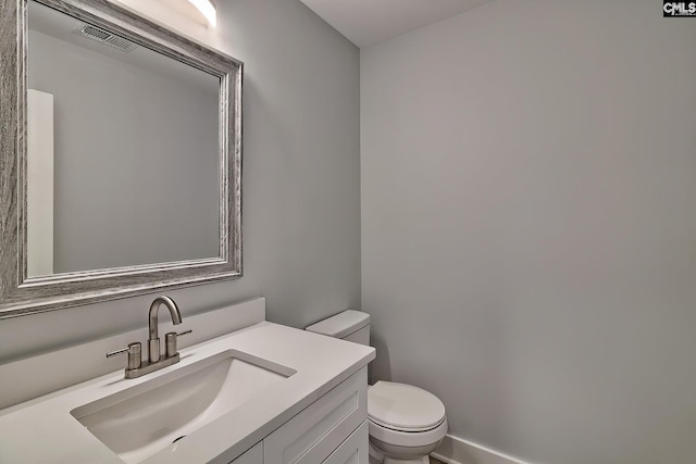 half bath featuring toilet and vanity