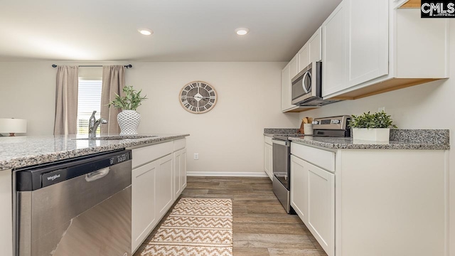 119 Shumard Ct, Columbia, SC 29203 - kitchen featuring stainless steel appliances, a sink, wood finished floors, white cabinets, and recessed lighting