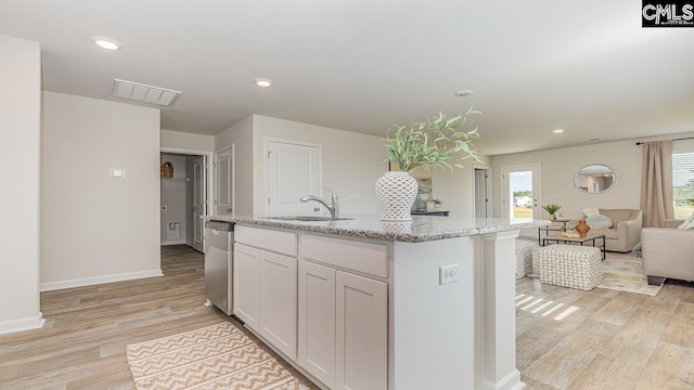 119 Shumard Ct, Columbia, SC 29203 - kitchen with a sink, light wood finished floors, light stone countertops, open floor plan, and white cabinetry