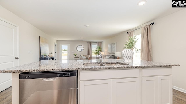 119 Shumard Ct, Columbia, SC 29203 - kitchen featuring stainless steel dishwasher, a sink, open floor plan, light wood finished floors, and white cabinetry