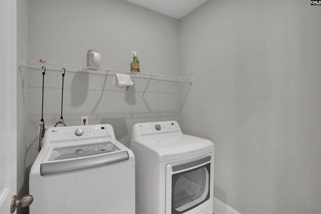 washroom with washing machine and dryer