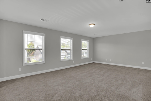 empty room featuring baseboards and carpet flooring