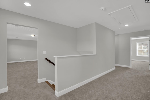 corridor featuring attic access, an upstairs landing, carpet floors, baseboards, and recessed lighting