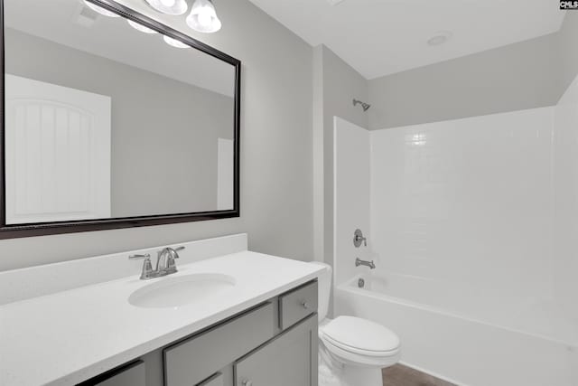 full bathroom featuring toilet, vanity, bathtub / shower combination, and wood finished floors