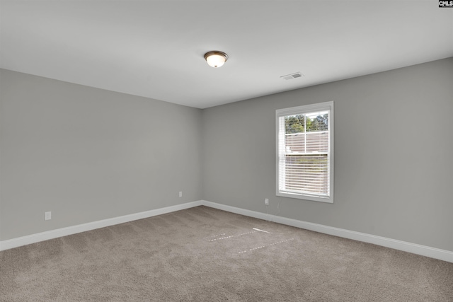 unfurnished room with carpet floors and baseboards