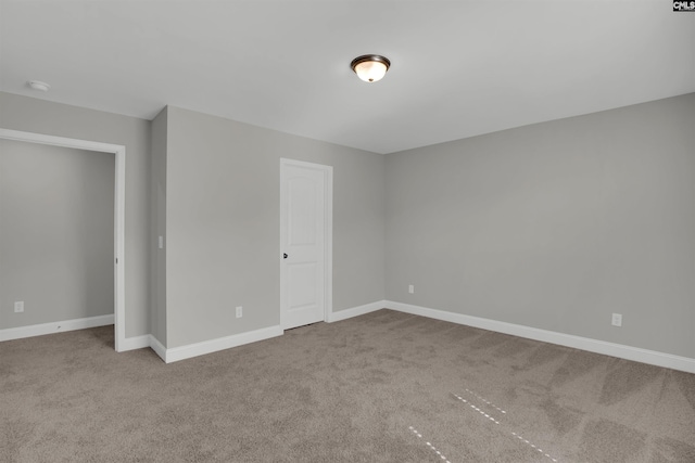 unfurnished bedroom with carpet and baseboards