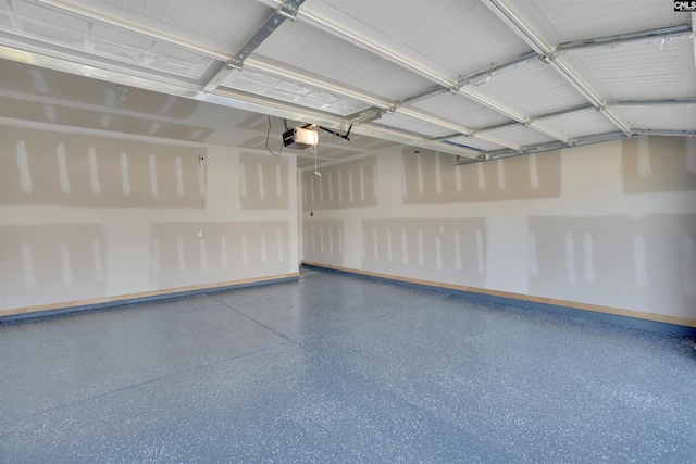 garage with a garage door opener and baseboards