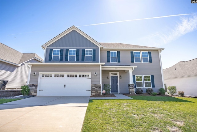 craftsman-style home featuring concrete driveway, a garage, a front yard, and stone siding