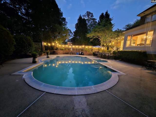 view of pool featuring a patio and fence