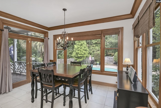 dining room with healthy amount of natural light, a chandelier, light tile patterned floors, french doors, and ornamental molding