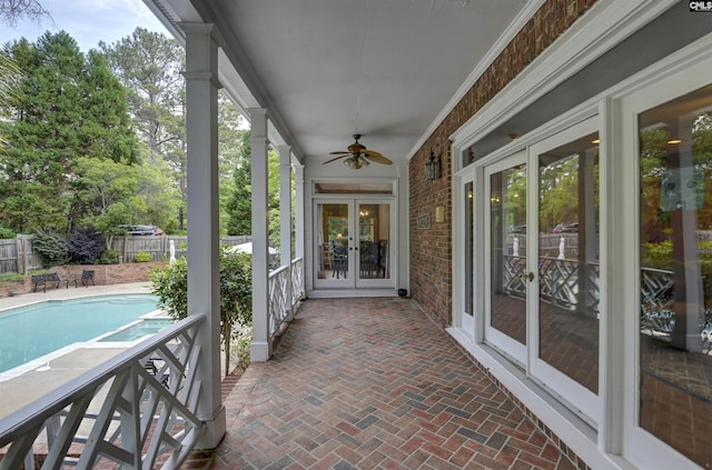 view of patio with french doors, fence, and a ceiling fan