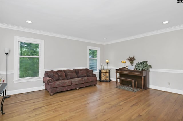 living area with wood finished floors, crown molding, baseboards, and recessed lighting