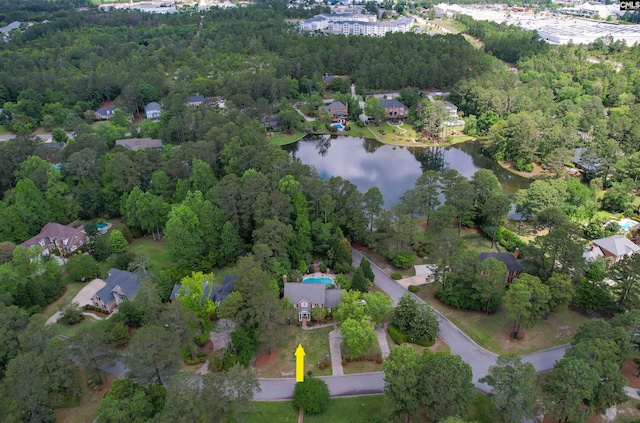 view of property location featuring a nearby body of water and nearby suburban area