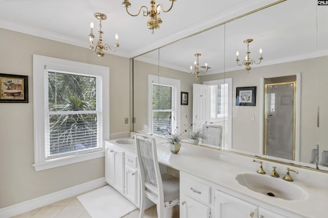 bathroom featuring a chandelier, crown molding, double vanity, and healthy amount of natural light
