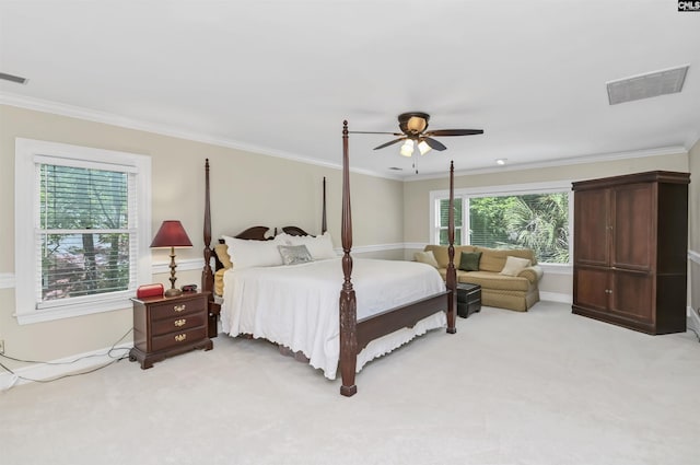 bedroom with light carpet, crown molding, a ceiling fan, and baseboards