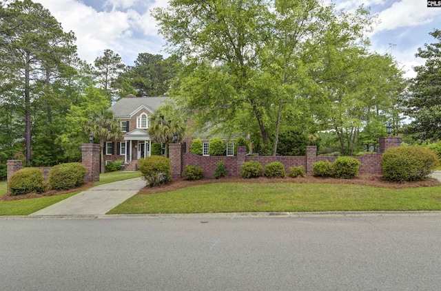 obstructed view of property featuring a front lawn