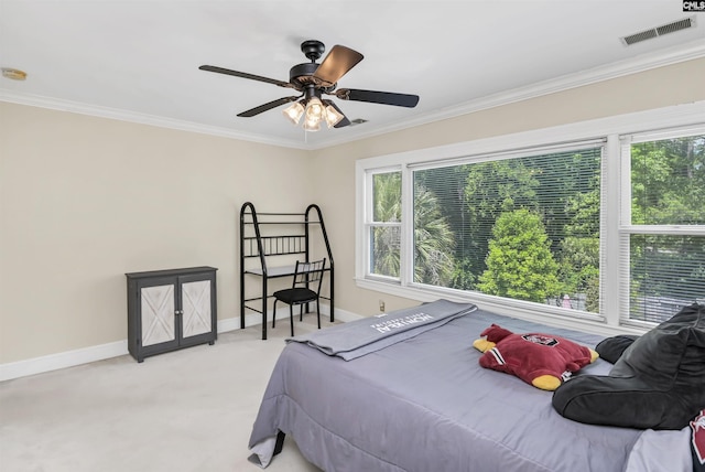 bedroom featuring crown molding, baseboards, carpet, and a ceiling fan