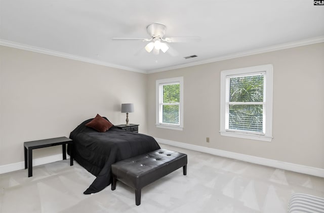 bedroom with baseboards, light carpet, crown molding, and a ceiling fan