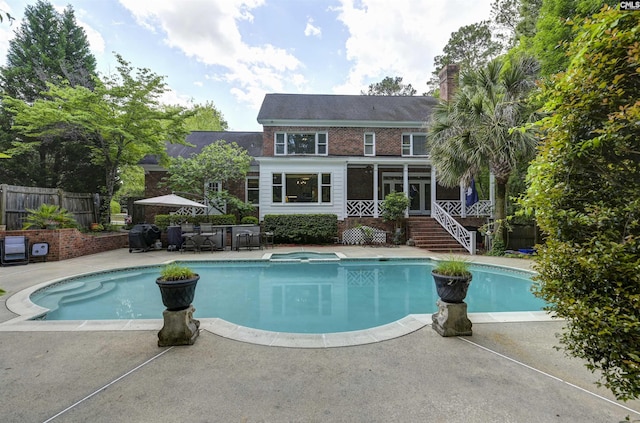 back of property featuring fence, a patio area, a chimney, and stairs