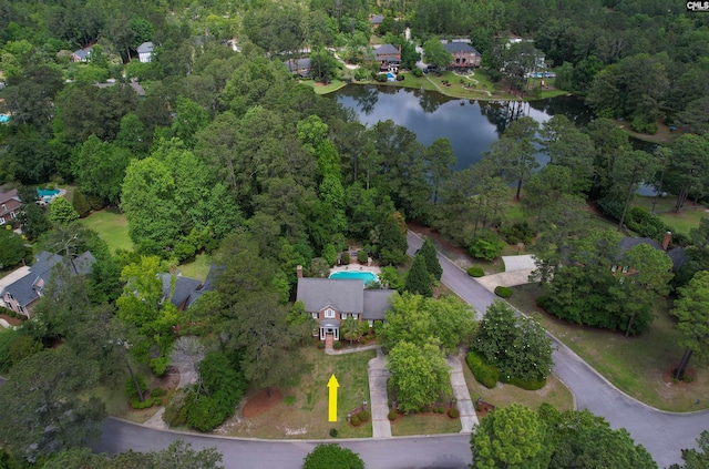 aerial view of property and surrounding area with a large body of water and nearby suburban area