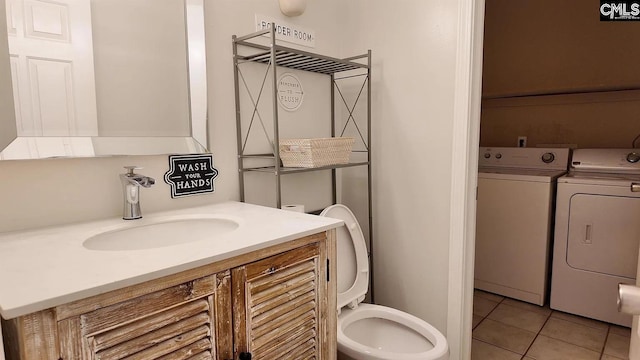 bathroom with washer and dryer, tile patterned floors, toilet, and vanity