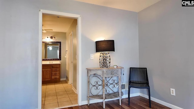 hallway featuring baseboards and wood finished floors