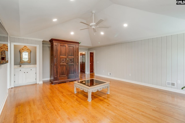 unfurnished living room featuring lofted ceiling, ceiling fan, light wood-style floors, recessed lighting, and baseboards