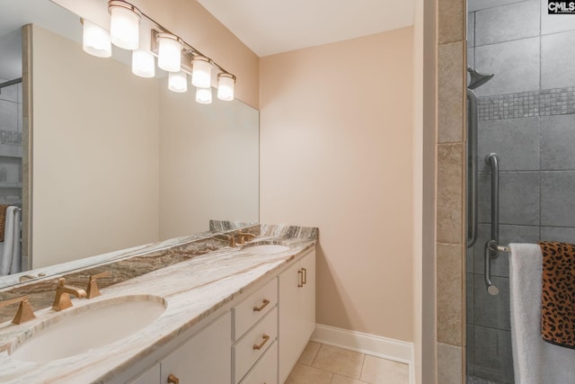full bathroom with tile patterned flooring, a shower stall, double vanity, and baseboards