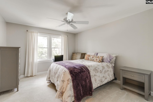bedroom with light carpet, baseboards, and ceiling fan
