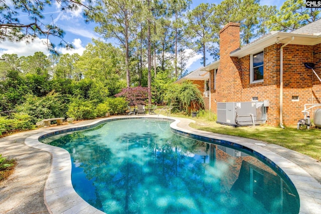 outdoor pool with cooling unit and a patio
