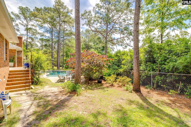 view of yard with fence and view of scattered trees