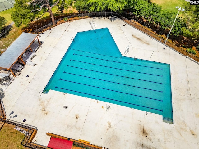 view of swimming pool with fence