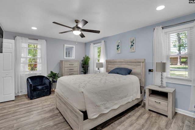 bedroom with wood finished floors, baseboards, recessed lighting, and a ceiling fan