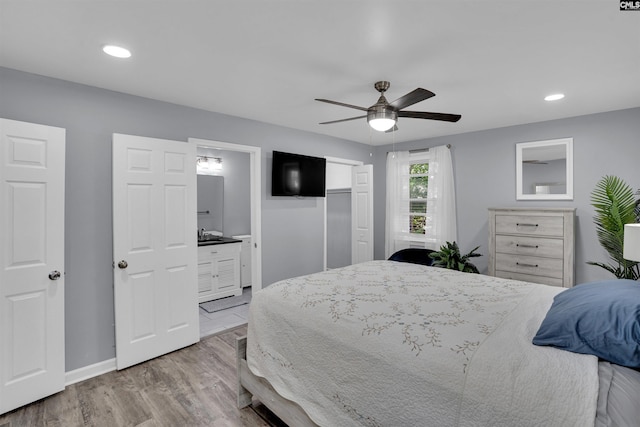 bedroom featuring wood finished floors, baseboards, recessed lighting, ceiling fan, and connected bathroom