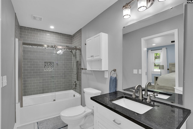 ensuite bathroom with toilet, vanity, and shower / bathtub combination