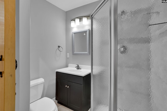bathroom with a shower stall, vanity, and toilet