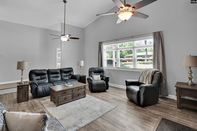 living room featuring ceiling fan, high vaulted ceiling, baseboards, wood finished floors, and crown molding