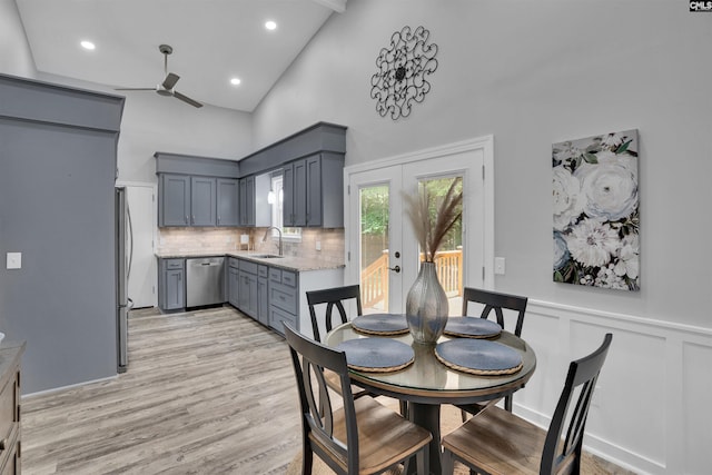 dining area featuring ceiling fan, high vaulted ceiling, light wood finished floors, and recessed lighting