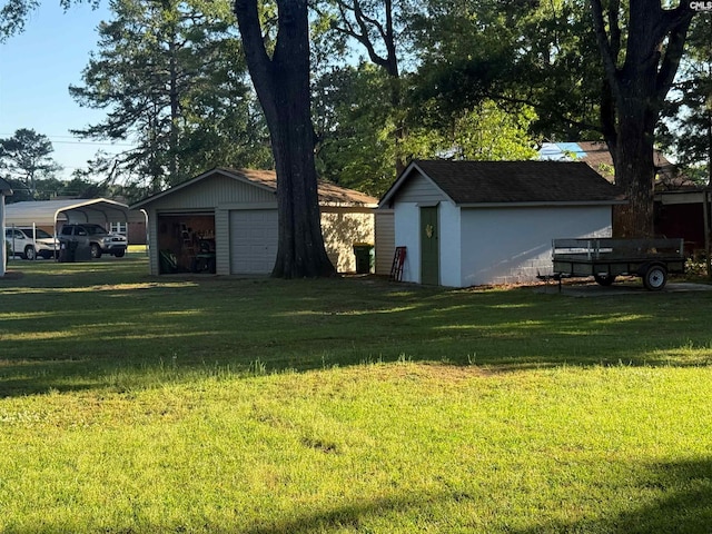 1006 W Main, Ridge Spring, SC 29129 - view of grassy yard featuring an outbuilding, a garage, a detached carport, and a shed