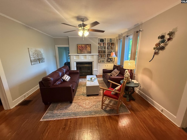 1006 W Main, Ridge Spring, SC 29129 - living area featuring a fireplace with flush hearth, ceiling fan, baseboards, wood finished floors, and ornamental molding