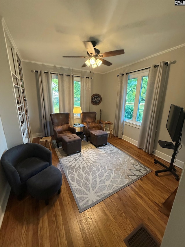 1006 W Main, Ridge Spring, SC 29129 - living room with wood finished floors, crown molding, ceiling fan, and baseboards