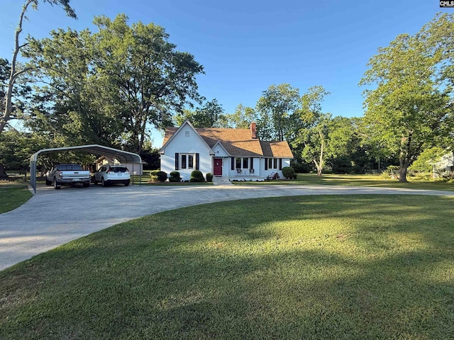 1006 W Main, Ridge Spring, SC 29129 - view of front of home featuring a detached carport, concrete driveway, a front yard, and a chimney