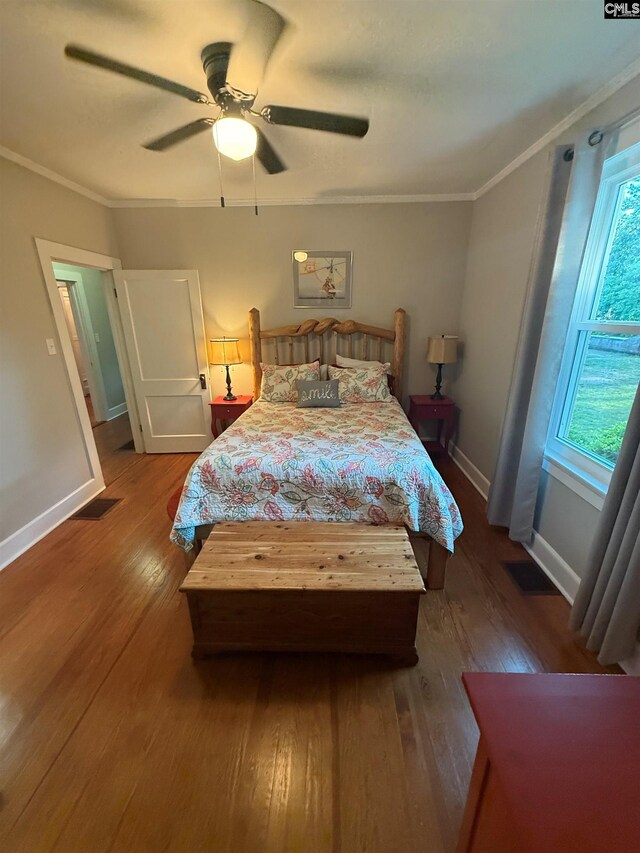 1006 W Main, Ridge Spring, SC 29129 - bedroom featuring wood-type flooring, multiple windows, ornamental molding, and baseboards