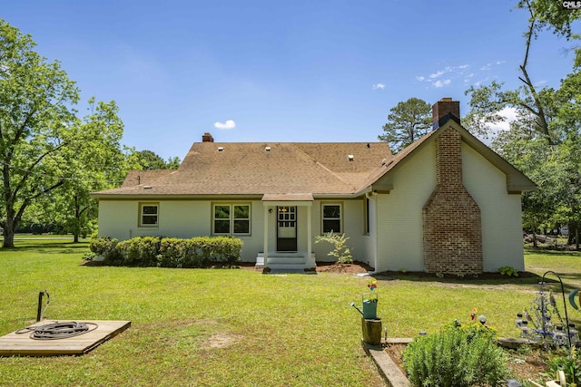 1006 W Main, Ridge Spring, SC 29129 - rear view of house featuring a yard, a chimney, brick siding, and a shingled roof
