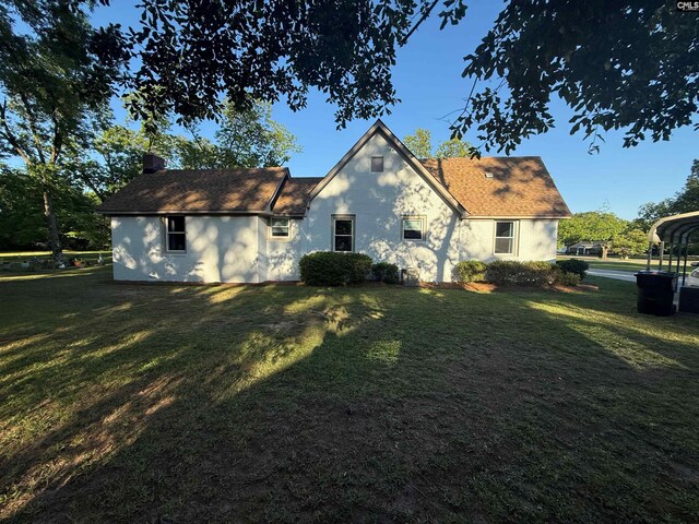 1006 W Main, Ridge Spring, SC 29129 - back of property featuring a yard, stucco siding, and a chimney