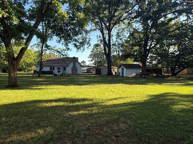 1006 W Main, Ridge Spring, SC 29129 - view of grassy yard featuring an outbuilding and a shed